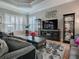 Bright living room featuring hardwood floors, a large television, and decor at 17694 Se 88Th Covington Cir, The Villages, FL 32162