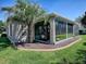 Exterior rear view showcasing the screened lanai and landscaped yard at 17694 Se 88Th Covington Cir, The Villages, FL 32162