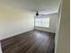 Bedroom with wood-look floors, a ceiling fan, and a window with blinds at 18203 Sandalwood Dr # 18203, Wildwood, FL 34785