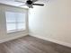 Bedroom featuring a ceiling fan, window, and wood-look flooring at 18203 Sandalwood Dr # 18203, Wildwood, FL 34785