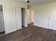 Bedroom with wood-look floors, a ceiling fan, and closet with doors at 18203 Sandalwood Dr # 18203, Wildwood, FL 34785