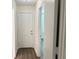 Bright hallway with wood-look floors and doors leading to rooms at 18203 Sandalwood Dr # 18203, Wildwood, FL 34785