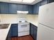 Cozy kitchen with blue cabinets, white countertops, and modern appliances at 18203 Sandalwood Dr # 18203, Wildwood, FL 34785