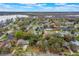 An aerial view of a lakeside community with mature trees at 1840 12Th St, Clermont, FL 34711