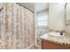 Bathroom featuring a shower-tub combination, granite vanity top, and an antique mirror at 1840 12Th St, Clermont, FL 34711