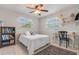 Well-lit bedroom with a comfortable bed, ceiling fan, and a charming bookshelf and decor at 1840 12Th St, Clermont, FL 34711