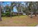 Traditional brick home with a well-kept lawn, complemented by mature trees providing shade and enhancing curb appeal at 1840 12Th St, Clermont, FL 34711