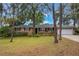Charming one-story brick home features a well-maintained yard with mature trees and a two-car garage at 1840 12Th St, Clermont, FL 34711