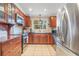 Bright kitchen with stainless steel refrigerator, microwave, tile floor and wooden cabinets at 1840 12Th St, Clermont, FL 34711