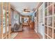 Inviting sunroom featuring exposed brick, a cozy armchair, and natural light from expansive windows at 1840 12Th St, Clermont, FL 34711