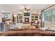 Inviting living room with fireplace, built-in shelving, tile flooring, and comfortable seating, perfect for relaxation at 1840 12Th St, Clermont, FL 34711