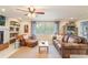 Bright living room features tile floors, a cozy fireplace, and comfortable seating, complemented by ample natural light at 1840 12Th St, Clermont, FL 34711