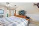 Comfortable main bedroom with ceiling fan, tile floors, and ensuite bath with double vanities at 1840 12Th St, Clermont, FL 34711