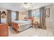 Cozy bedroom featuring tile floors, a wood bedframe, and soft lighting at 1840 12Th St, Clermont, FL 34711