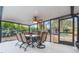 Covered patio with a dining table and chairs, perfect for enjoying outdoor meals near lush foliage at 1840 12Th St, Clermont, FL 34711