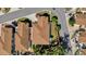 Birds-eye view showcases a meticulously landscaped property with lush greenery, manicured lawns, and privacy fencing at 1923 Greeleyville Ter, The Villages, FL 32162