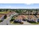 Aerial view of a neighborhood featuring residential homes with manicured lawns, golf course, and green landscaping at 1923 Greeleyville Ter, The Villages, FL 32162