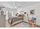 Cozy bedroom features a floral bedspread, neutral walls, and a bright window at 1923 Greeleyville Ter, The Villages, FL 32162