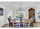 Cozy dining area featuring a wooden table, upholstered chairs, a china cabinet, and bright natural light at 1923 Greeleyville Ter, The Villages, FL 32162