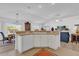 Open kitchen layout with a breakfast bar overlooking the dining and living areas at 1923 Greeleyville Ter, The Villages, FL 32162
