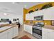 Bright kitchen with white cabinets, stainless appliances, and seamless access to the living area at 1923 Greeleyville Ter, The Villages, FL 32162