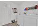 Functional laundry room with washer, dryer, utility sink, and storage shelving at 1923 Greeleyville Ter, The Villages, FL 32162