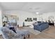 Bright and airy living room with comfortable seating, modern decor, and sliding doors to the outdoors at 1923 Greeleyville Ter, The Villages, FL 32162