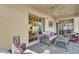 Covered patio area features comfortable seating and a view of the outdoor scenery at 1923 Greeleyville Ter, The Villages, FL 32162
