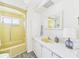 Bathroom with a vanity, sink, and retro yellow shower and tub at 2 Heather Ln, Fruitland Park, FL 34731