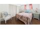 Comfortable bedroom with a floral quilt, chair, and slider closet doors at 2 Heather Ln, Fruitland Park, FL 34731