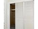 View of a closet with sliding doors and built-in shelving for ample storage at 2 Heather Ln, Fruitland Park, FL 34731