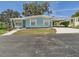 Inviting home exterior with a cozy carport, complemented by a well-maintained front yard and landscaping at 2 Heather Ln, Fruitland Park, FL 34731