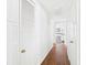 Hallway boasts wood flooring, storage closet, and seamless transition to adjacent room, complemented by a neutral color palette at 2 Heather Ln, Fruitland Park, FL 34731