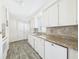 Updated kitchen with lots of cabinet space, laminate countertops, stainless steel double sinks, and modern appliances at 2 Heather Ln, Fruitland Park, FL 34731