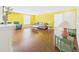 Spacious living room featuring wood floors, bright yellow walls, comfortable seating, and ample natural light at 2 Heather Ln, Fruitland Park, FL 34731