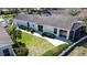 Aerial view of the home, showcasing the backyard, screened-in lanai, and the surrounding landscaping at 2065 Braxton St, Clermont, FL 34711