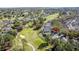 Aerial view of a neighborhood backing onto a golf course, with mature trees at 2065 Braxton St, Clermont, FL 34711