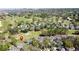 Aerial view of a residential community surrounded by a lush golf course and mature trees at 2065 Braxton St, Clermont, FL 34711