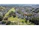 A high view of houses surrounded by trees and backing onto a golf course at 2065 Braxton St, Clermont, FL 34711