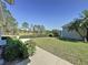 A peaceful backyard with lush lawn and mature landscaping overlooking the golf course at 2065 Braxton St, Clermont, FL 34711