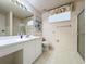 Clean bathroom with a single sink vanity, framed mirror, and a glass-enclosed shower at 2065 Braxton St, Clermont, FL 34711