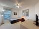 Bedroom featuring a ceiling fan, large window, and neutral décor, creating a cozy and peaceful living space at 2065 Braxton St, Clermont, FL 34711
