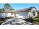 Well-maintained single-story home with a two-car garage, neat landscaping, and a welcoming driveway at 2065 Braxton St, Clermont, FL 34711