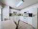 Functional kitchen area featuring white cabinets, laminate countertops, and modern appliances at 2065 Braxton St, Clermont, FL 34711
