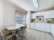 Functional kitchen area featuring white cabinets, laminate countertops, and a pleasant dining space at 2065 Braxton St, Clermont, FL 34711