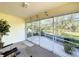 Covered lanai with sliding glass doors offering an expansive view of lush greenery and the outdoors at 2065 Braxton St, Clermont, FL 34711