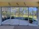 Enclosed lanai featuring a view of the beautiful golf course with clear sliding doors offering a seamless transition at 2065 Braxton St, Clermont, FL 34711