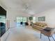 Inviting living room featuring a comfortable seating area and sliding glass doors offering a view of the outdoors at 2065 Braxton St, Clermont, FL 34711