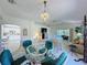 Bright living room featuring a glass table and access to the outdoor patio with natural light at 2065 Braxton St, Clermont, FL 34711