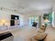 Bright living room featuring a couch and sliding doors to the outdoor patio with natural light at 2065 Braxton St, Clermont, FL 34711